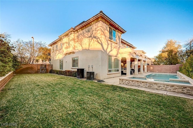 rear view of property featuring a pool with hot tub, a yard, and cooling unit