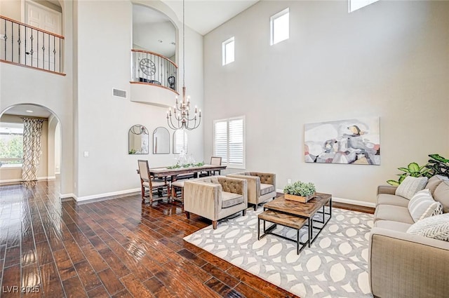 living room with a high ceiling and a chandelier