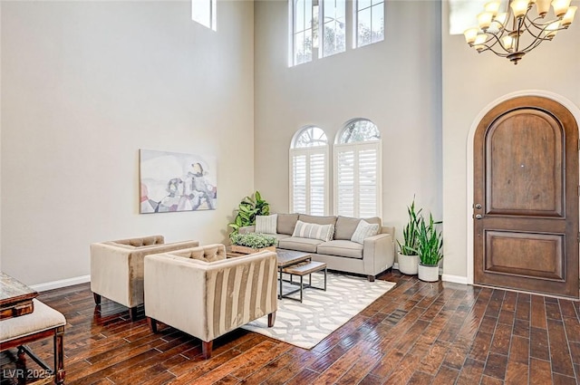 living room featuring a towering ceiling and an inviting chandelier