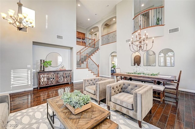 living room featuring a high ceiling, a chandelier, and a wealth of natural light