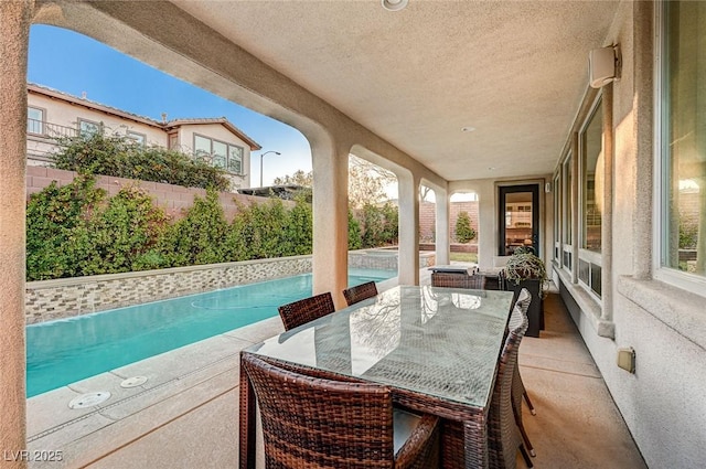 view of patio / terrace with a fenced in pool