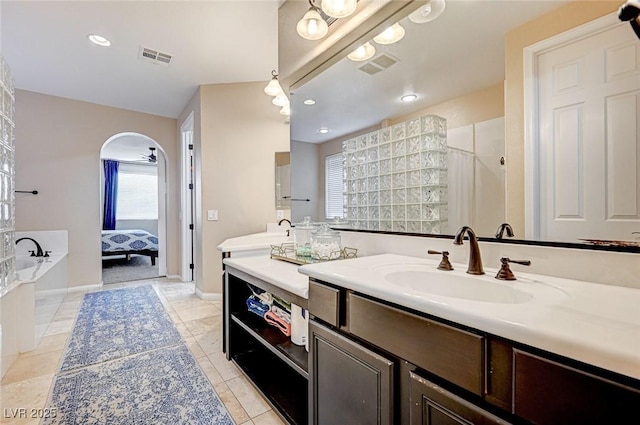 bathroom featuring vanity, tile patterned flooring, and separate shower and tub