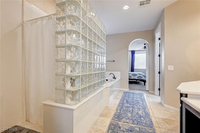 bathroom with plus walk in shower, ceiling fan, and vanity