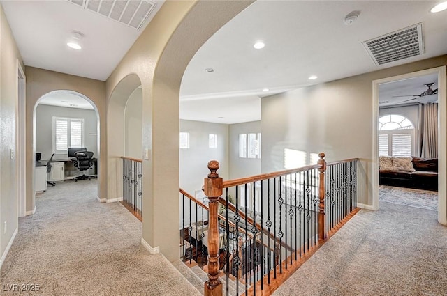 hall featuring light colored carpet