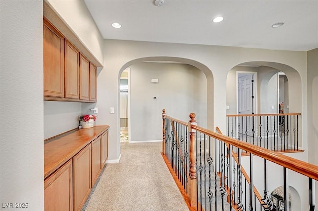 hallway with light colored carpet