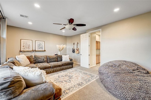 living room featuring ceiling fan and light colored carpet