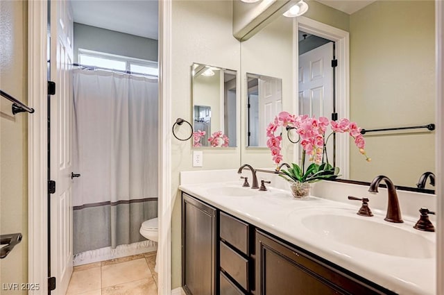 bathroom with walk in shower, vanity, tile patterned floors, and toilet