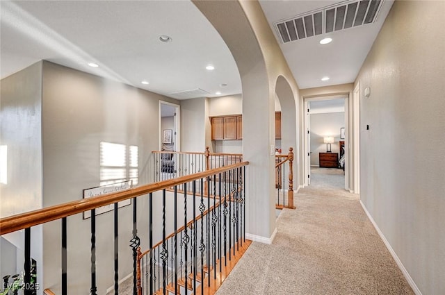 hallway featuring light carpet