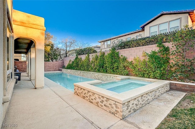 view of pool with an in ground hot tub