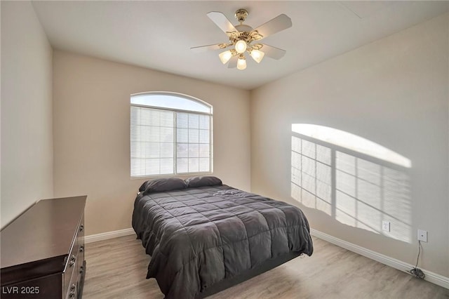 bedroom with ceiling fan and light hardwood / wood-style flooring