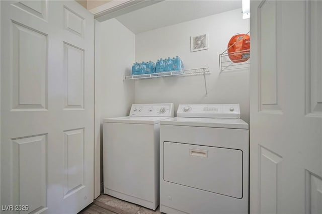 clothes washing area featuring washer and clothes dryer