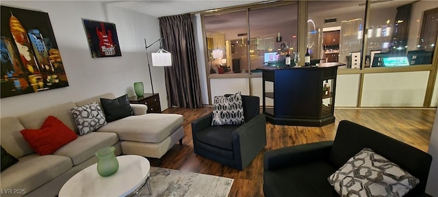 living room featuring floor to ceiling windows and dark wood-type flooring