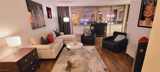 living room featuring a chandelier and dark hardwood / wood-style flooring