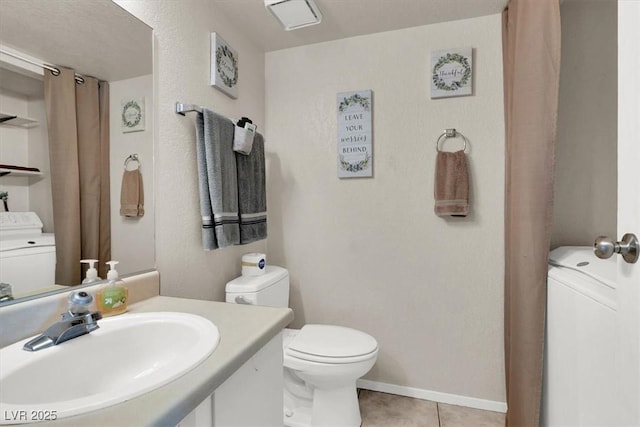 bathroom with washer / dryer, tile patterned flooring, toilet, and vanity