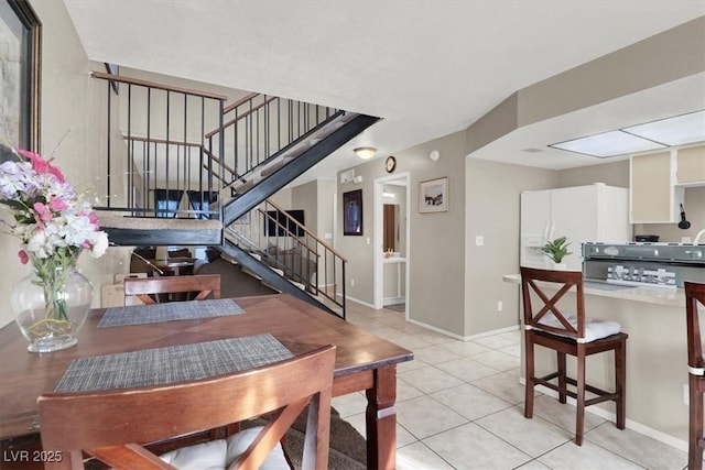 dining space featuring light tile patterned floors