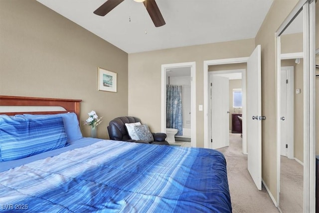 bedroom with ensuite bath, ceiling fan, and light carpet