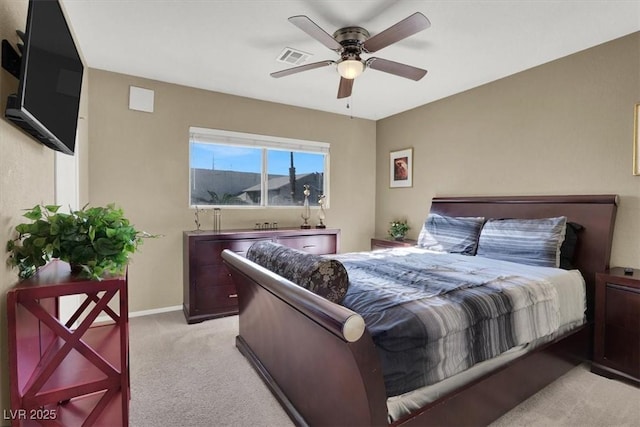 bedroom with ceiling fan and light carpet