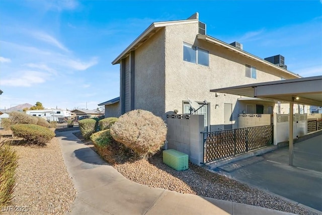 view of property exterior with central AC