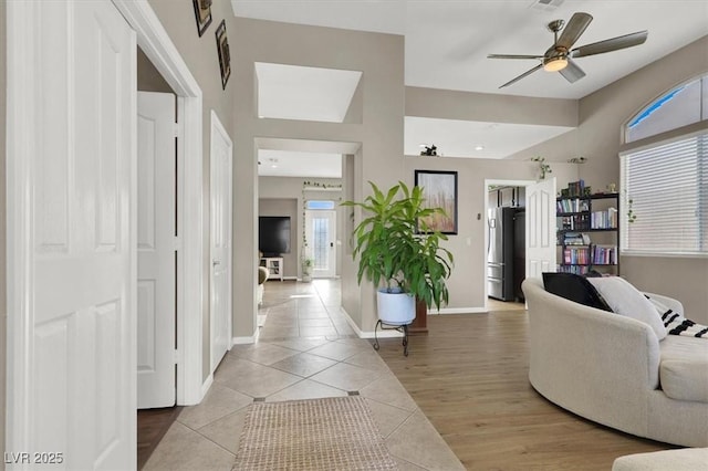 tiled living room featuring ceiling fan