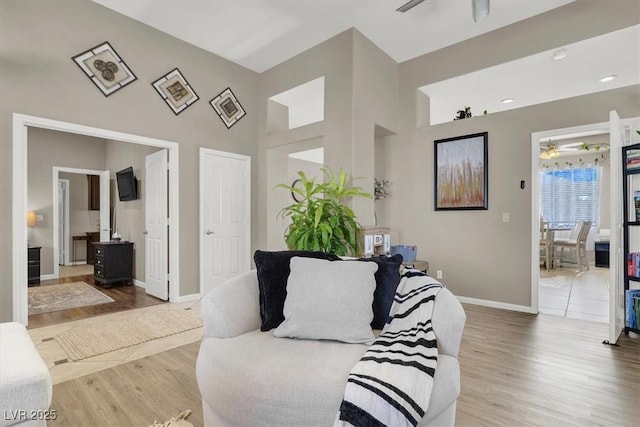 living room featuring hardwood / wood-style flooring and ceiling fan