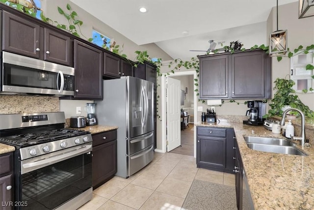 kitchen featuring dark brown cabinets, appliances with stainless steel finishes, hanging light fixtures, and sink