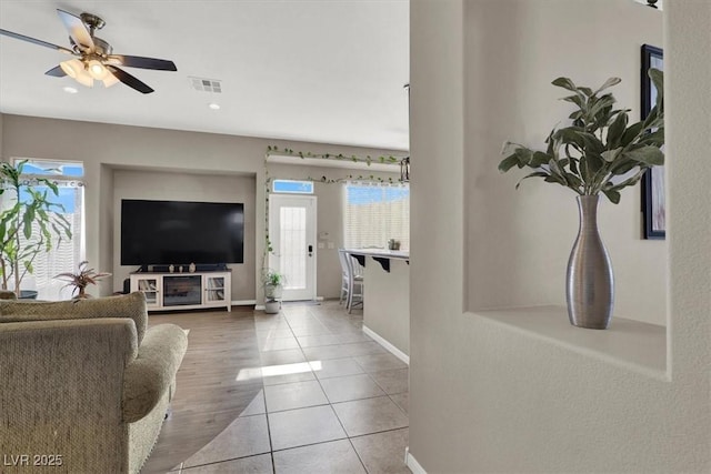 tiled living room with ceiling fan