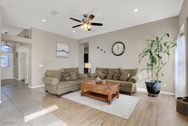 living room with ceiling fan and light hardwood / wood-style floors