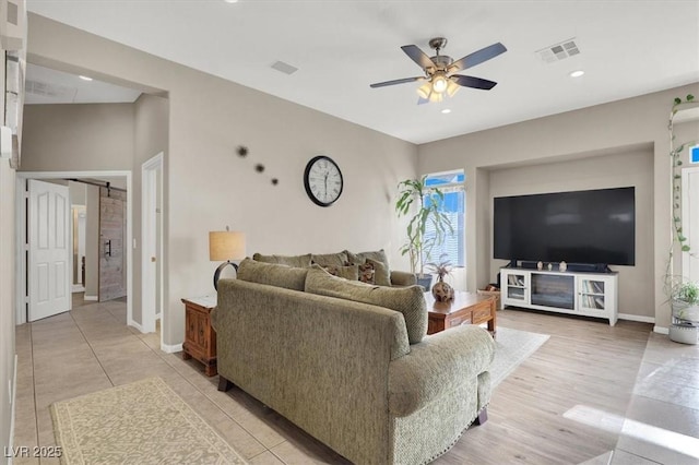 living room with ceiling fan and light hardwood / wood-style floors