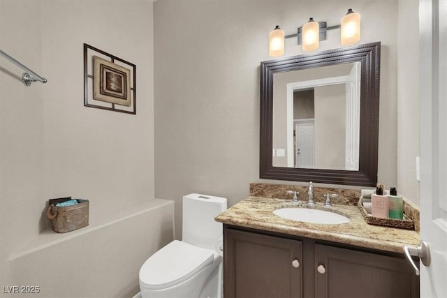 bathroom with vanity and toilet