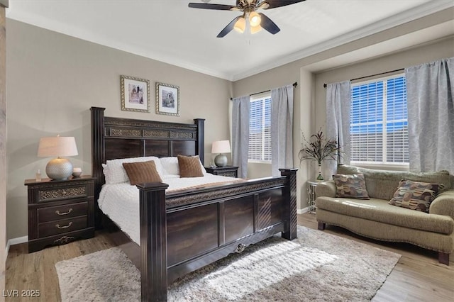 bedroom featuring crown molding, ceiling fan, and light hardwood / wood-style flooring