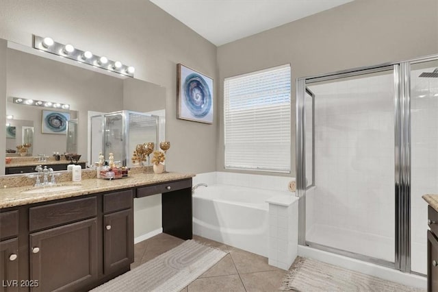 bathroom with plus walk in shower, tile patterned floors, and vanity