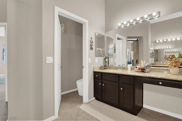 bathroom featuring toilet, tile patterned floors, and vanity