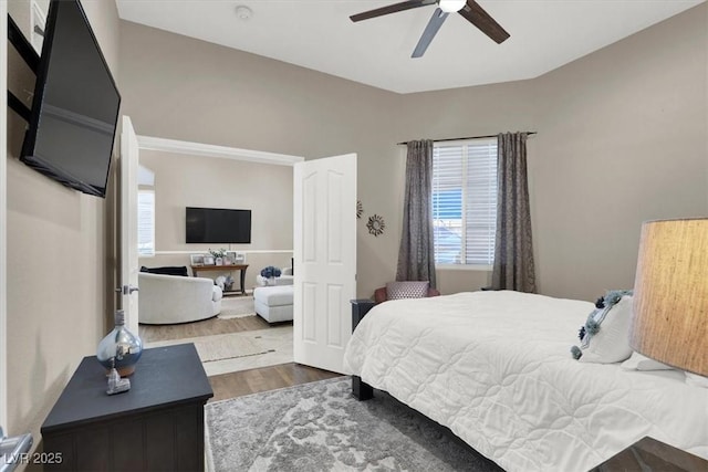 bedroom with ceiling fan and hardwood / wood-style flooring