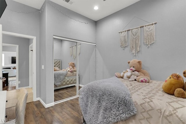 bedroom featuring a closet and dark hardwood / wood-style flooring