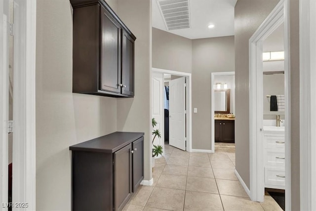 hall with light tile patterned floors