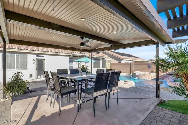 view of patio with ceiling fan, pool water feature, and a fenced in pool