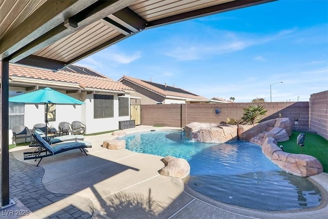 view of swimming pool with a patio and pool water feature