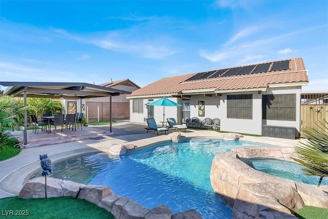 view of swimming pool featuring an in ground hot tub and a patio area