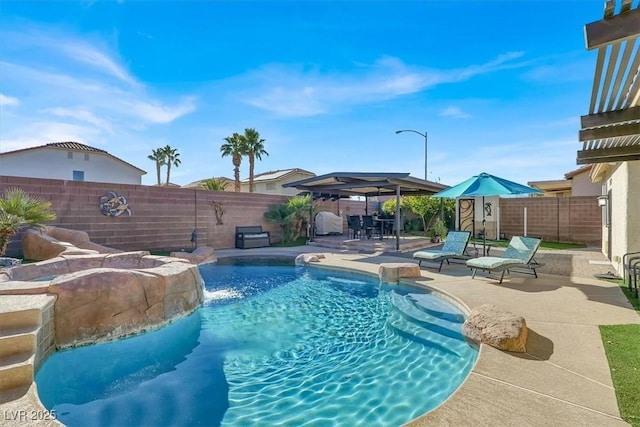 view of swimming pool with a gazebo, pool water feature, and a patio area