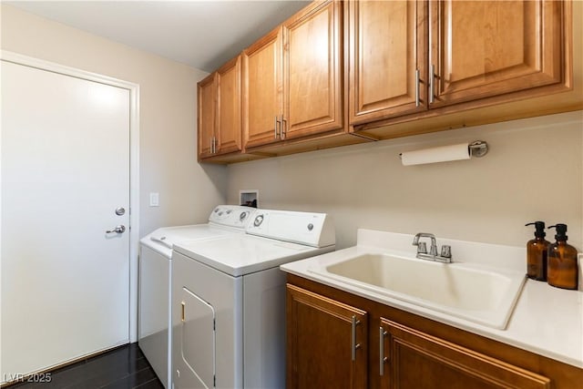 washroom with washer and dryer, cabinets, and sink