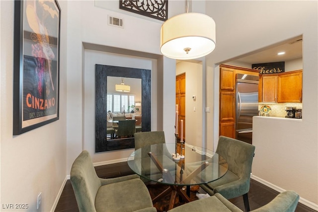 dining area with dark hardwood / wood-style floors