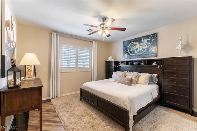 bedroom with ceiling fan and light hardwood / wood-style flooring