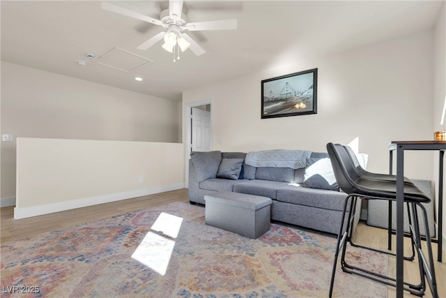 living room with ceiling fan and light hardwood / wood-style floors