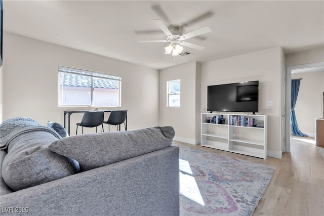 living room featuring ceiling fan and light wood-type flooring