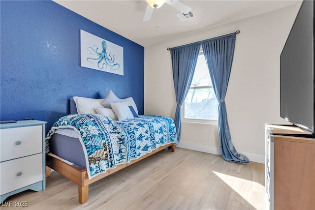 bedroom featuring ceiling fan and light hardwood / wood-style flooring