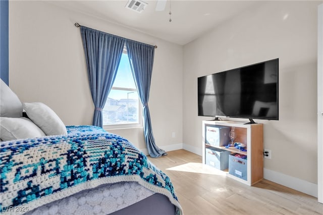 bedroom with ceiling fan and light wood-type flooring