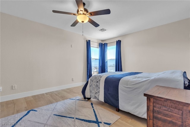 bedroom with ceiling fan and light hardwood / wood-style flooring