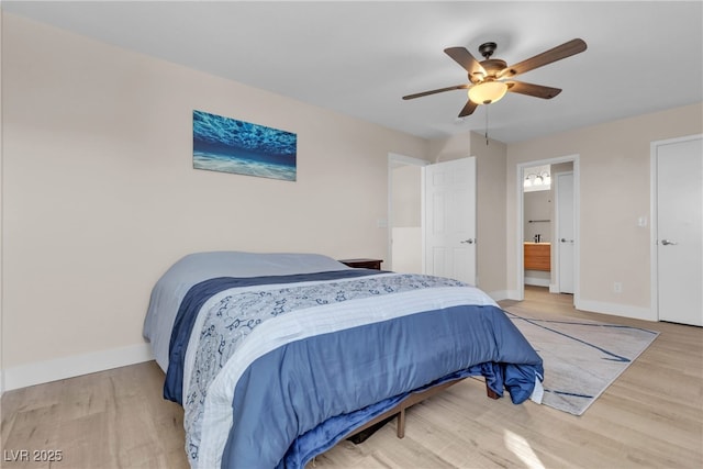 bedroom featuring ceiling fan, ensuite bathroom, and wood-type flooring