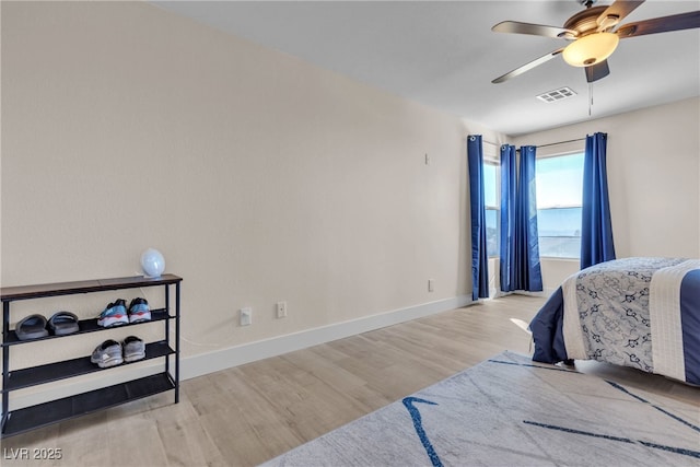 bedroom with ceiling fan and light hardwood / wood-style flooring