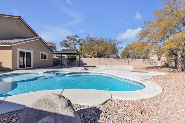 view of swimming pool with a gazebo, a patio area, and an in ground hot tub